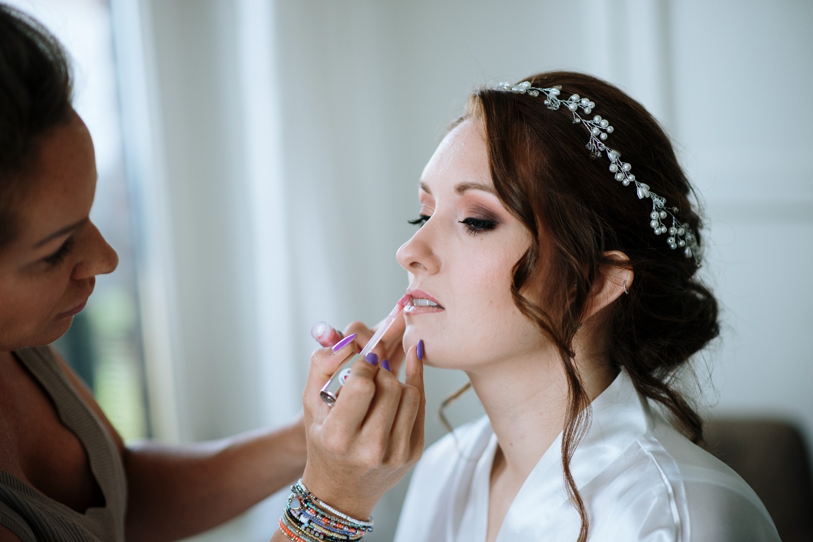 makeup wordt gedaan bij een bruid